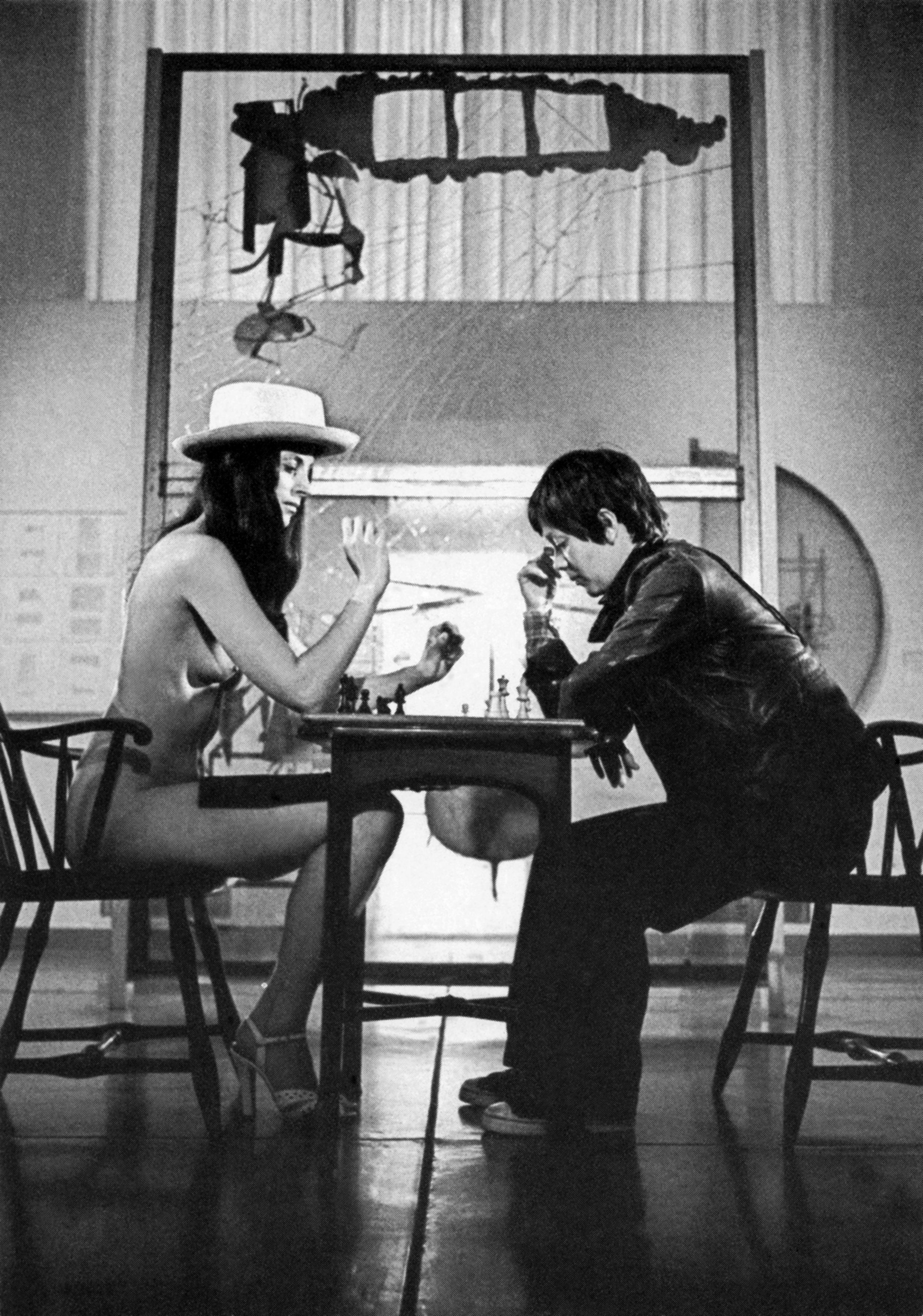 Hannah Wilke
C&amp;rsquo;est La Vie Rrose, 1976
Hannah Wilke playing chess with I Sa Lo in still from
Wilke documentary, Philly, used by Wilke in a poster for
the film C&amp;rsquo;est La Vie Rrose.
Hannah Wilke Collection &amp;amp; Archive, Los Angeles.
Courtesy Electronic Arts Intermix, New York.